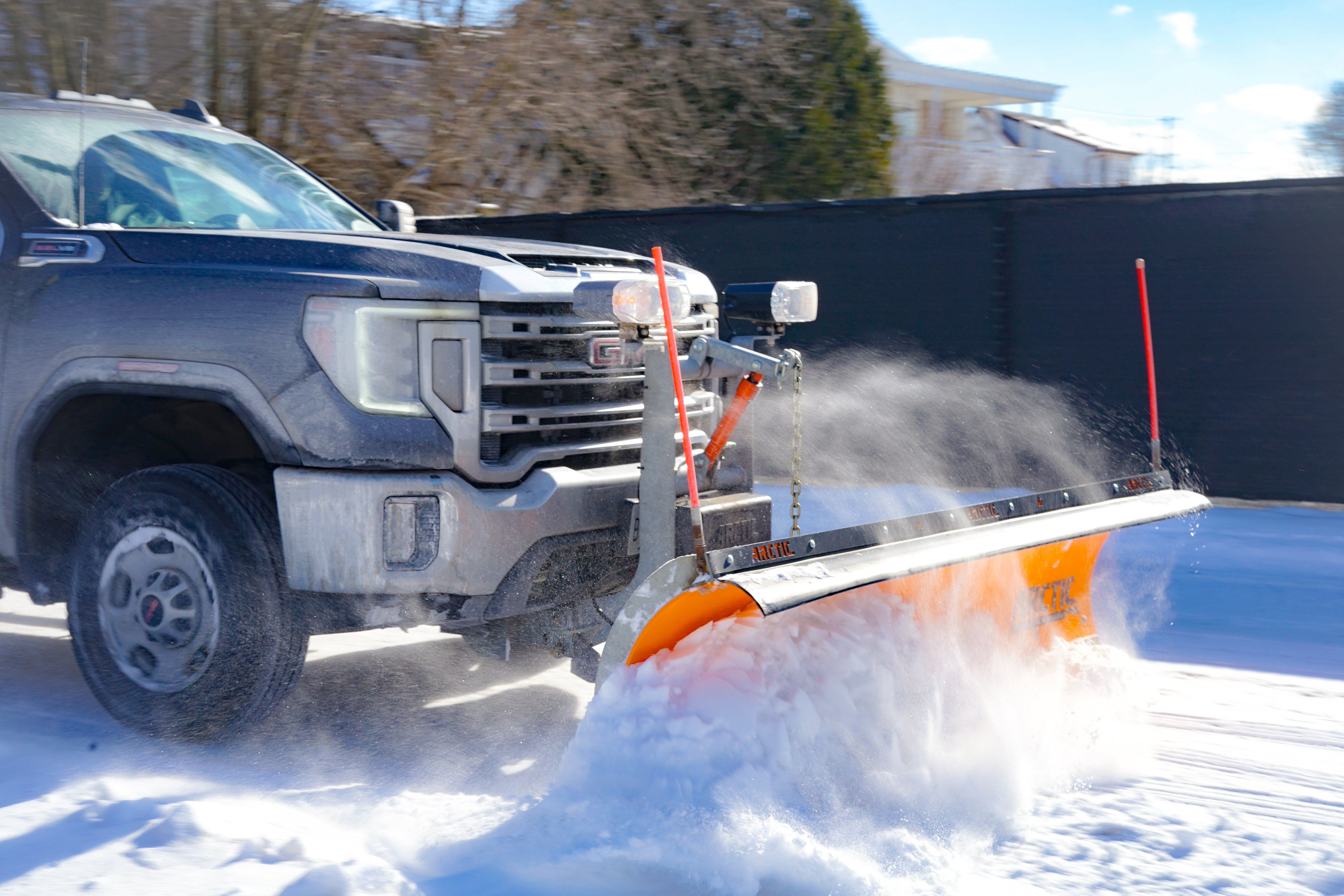 Car equipped with snow removal equipment clearing snow
