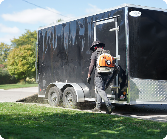 Man using grass removal machine to clear lawn